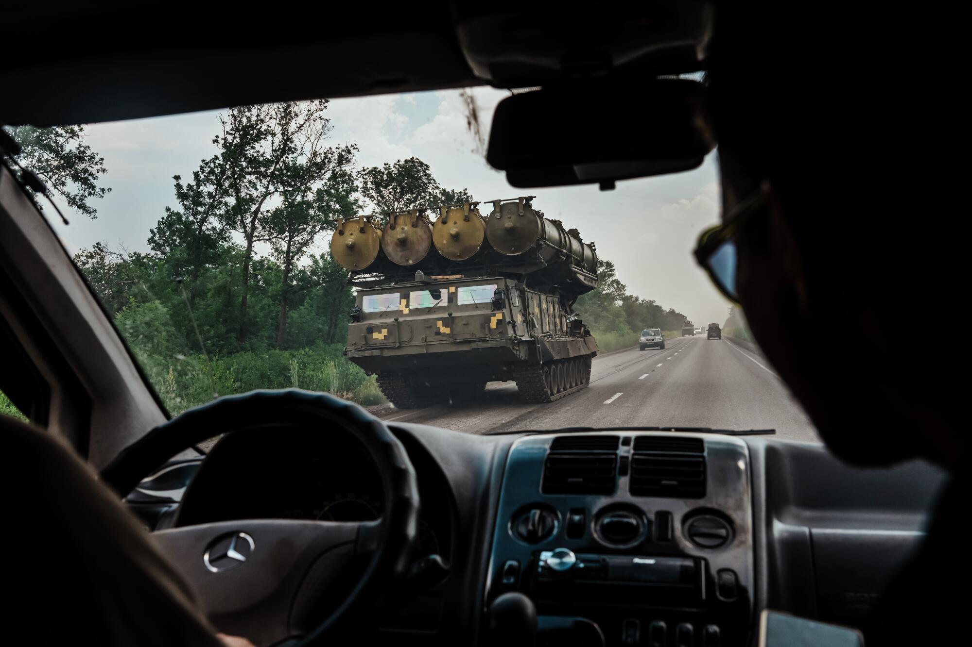 A military rocket launcher drives on a highway towards Lysychansk, Ukraine.