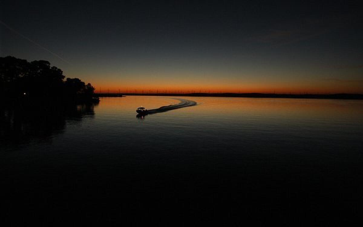 A boater heads for home port as the sun sets on the Sacramento-San Joaquin delta near the town of Rio Vista.