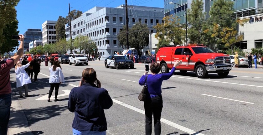 Burbank's healthcare workers on the front lines of the coronavirus pandemic were honored by the city's fire and police departments on Wednesday with a motor procession outside of Providence St. Joseph Medical Center.