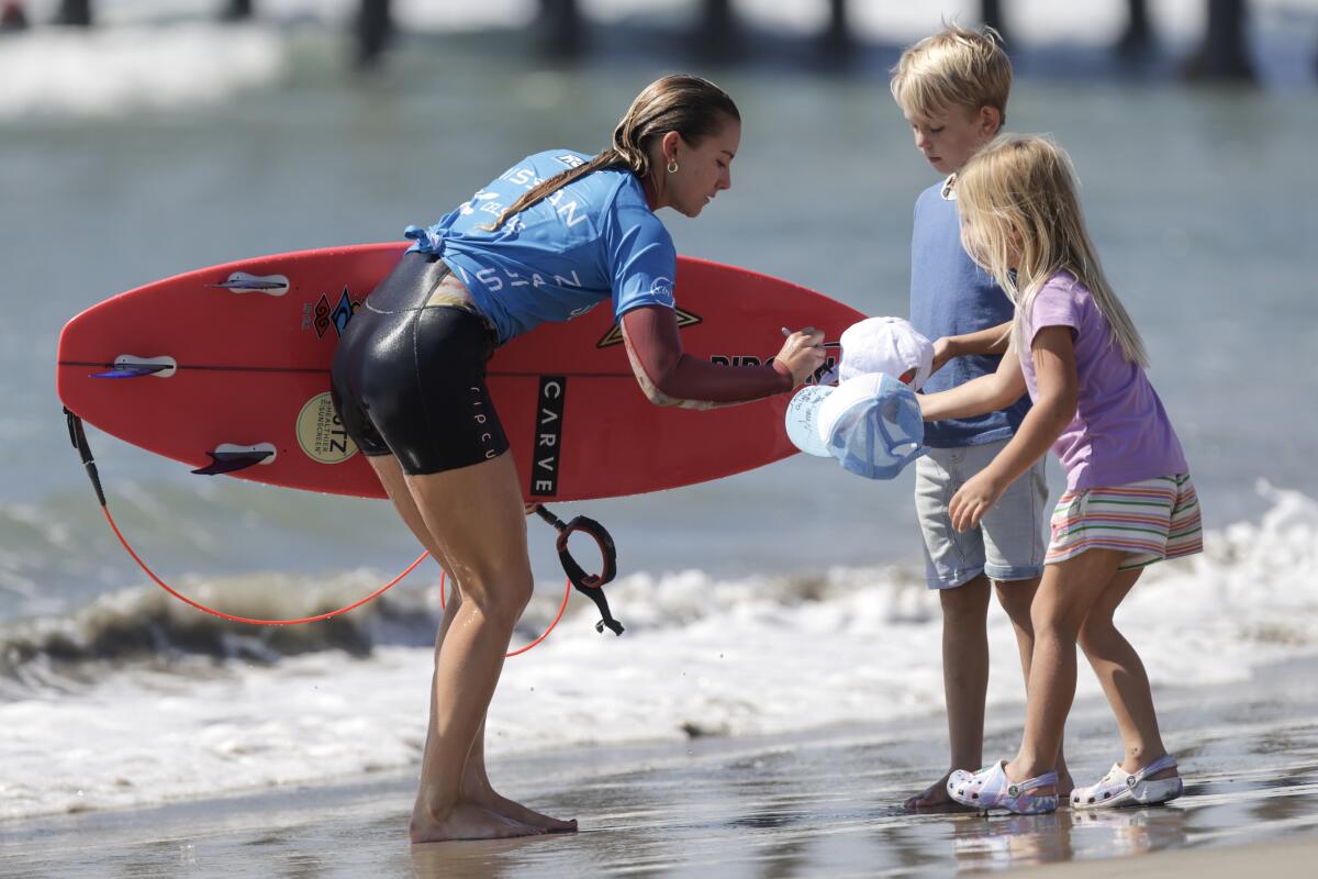 Alyssa Spencer signs autographs after advancing to the final heat during the Nissan Super Girl Surf Pro.