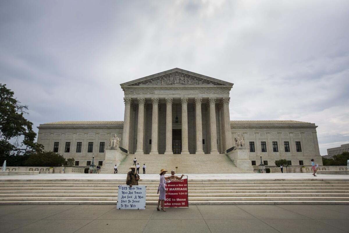 Anti-gay marriage protestors gather outside the Supreme Court, where justices will soon reveal their decision on several high profile cases, including Obamacare and gay marriage, in Washington on June 15.