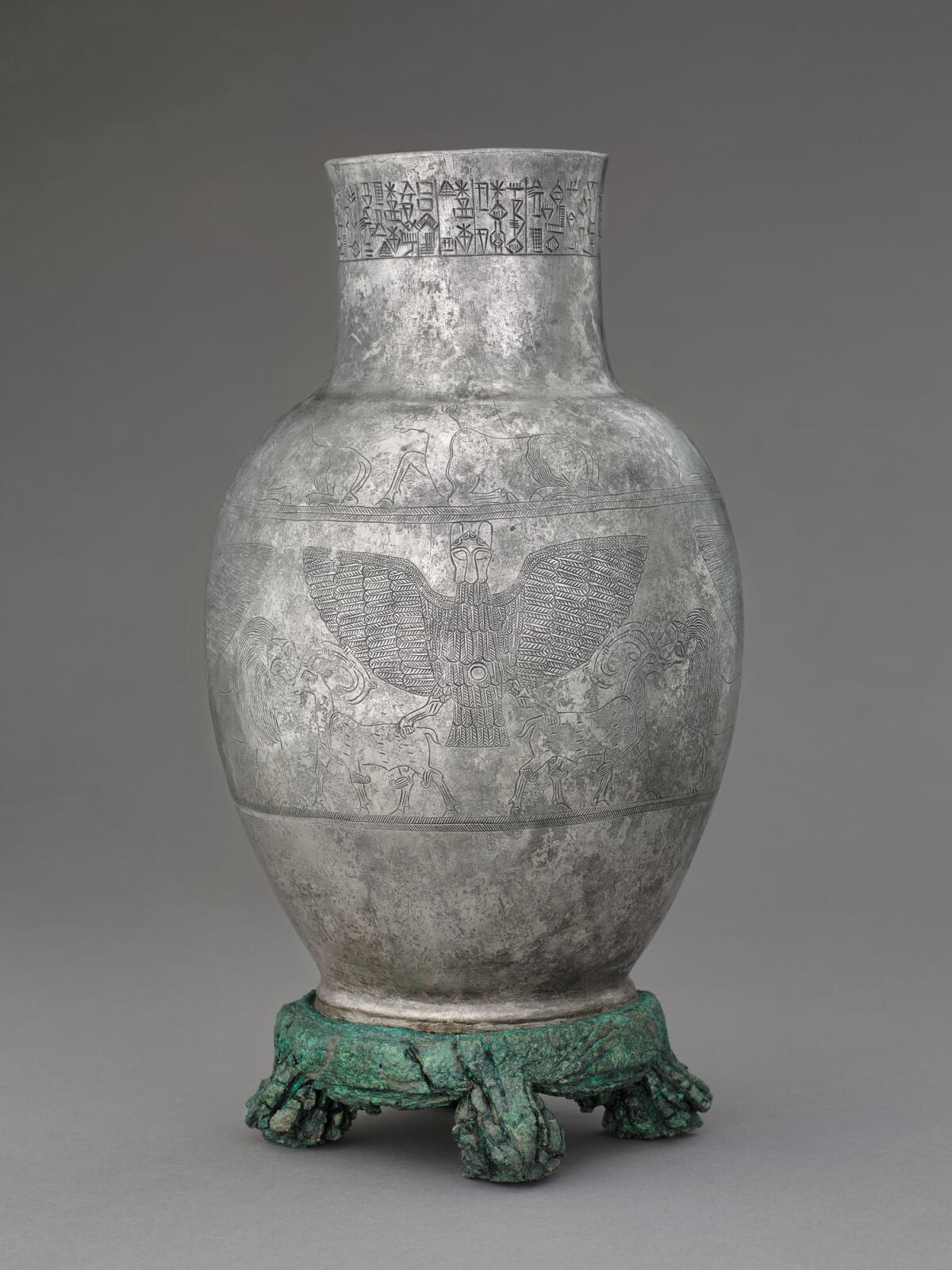 A devotional vessel made of silver and copper alloy, depicting a lion-headed eagle.