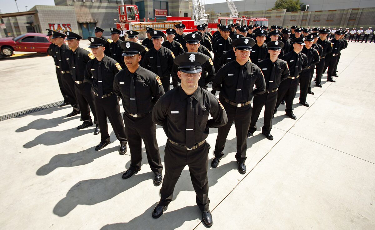 The 58 latest recruits of the Los Angeles Fire Department stand in formation during their graduation ceremony in Panorama City in June.