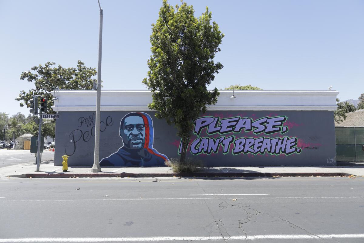 The side of a building with a depiction of George Floyd and the words "Please, I can't breathe."