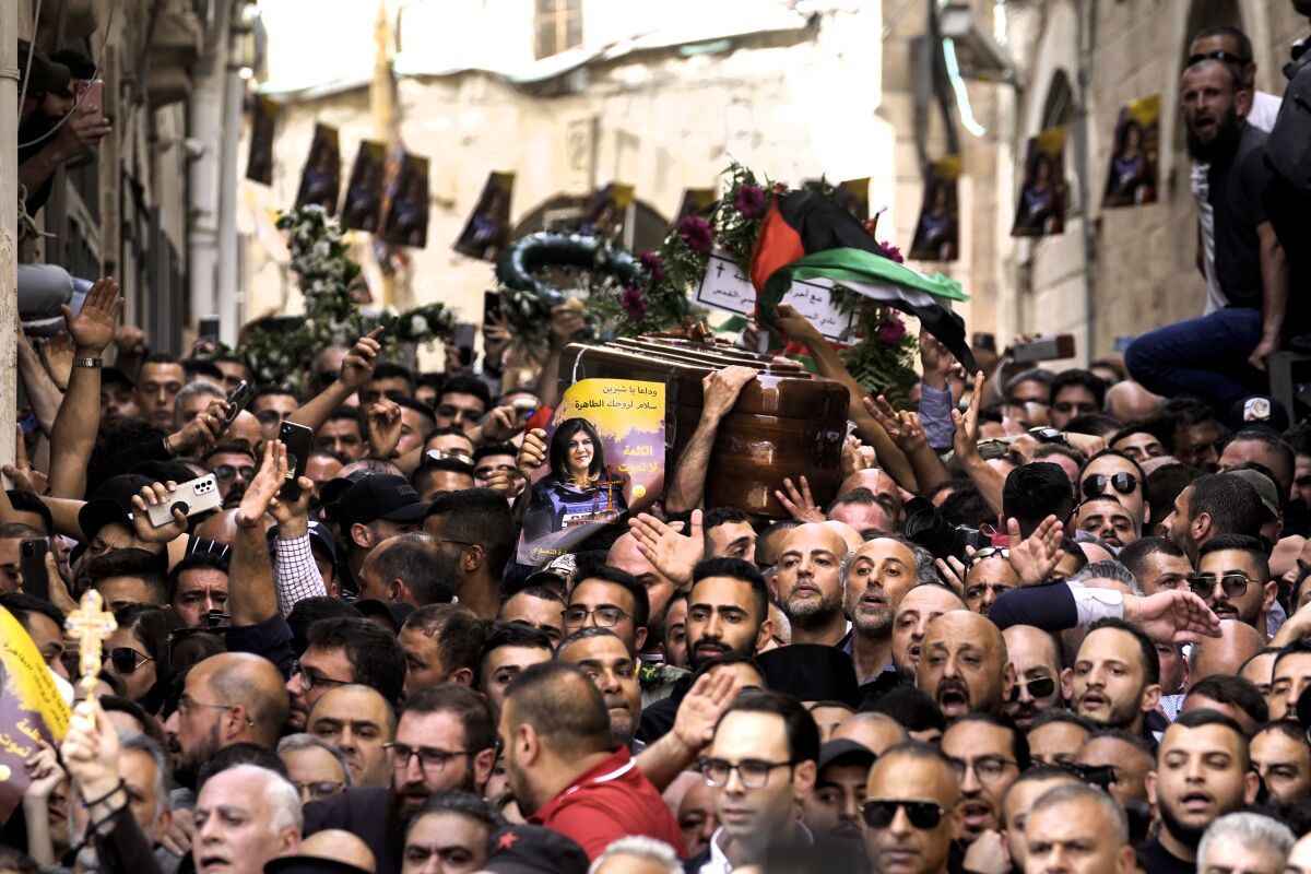 Mourners carry the casket of slain Al Jazeera journalist Shireen Abu Akleh during her funeral in Jerusalem's Old City.