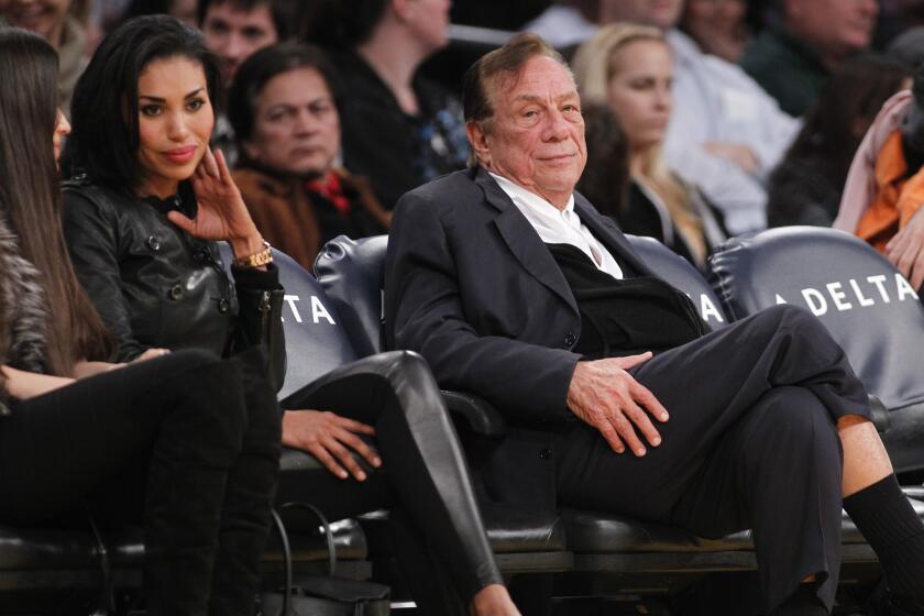 Los Angeles Clippers owner Donald Sterling, right, and V. Stiviano, left, watch the Clippers play the Los Angeles Lakers in December 2011.