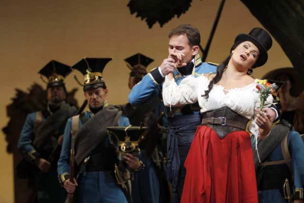 Mariusz Kwiecien performs alongside Anna Netrebko in a scene from Donizetti's "The Elixir of Love" at the Metropolitan Opera in New York.