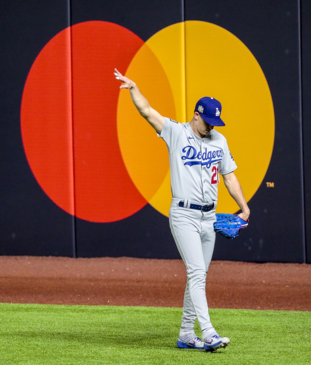 Dodgers starting pitcher Walker Buehler stretches in the outfield before Game 3 of the World Series on Friday.