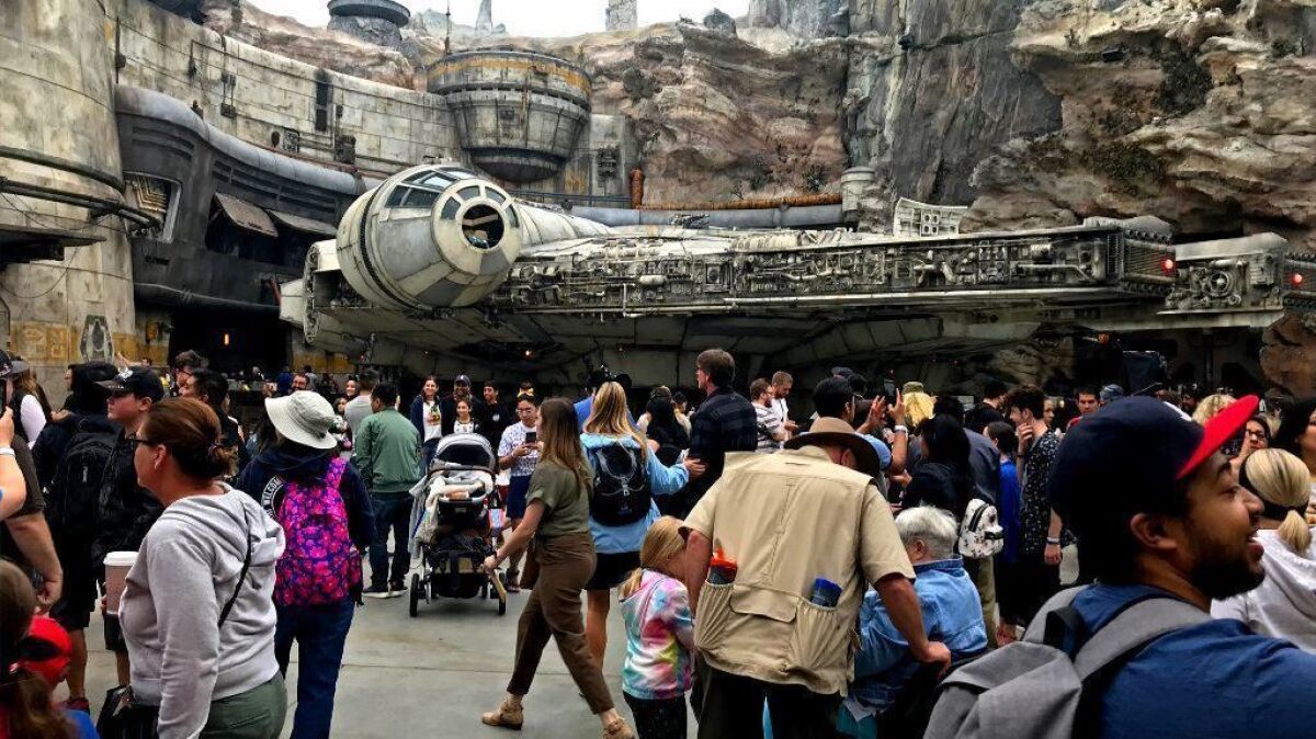 Opening-day crowds walk past the Millennium Falcon at Disneyland's Star Wars: Galaxy's Edge attraction in Anaheim on May 31.