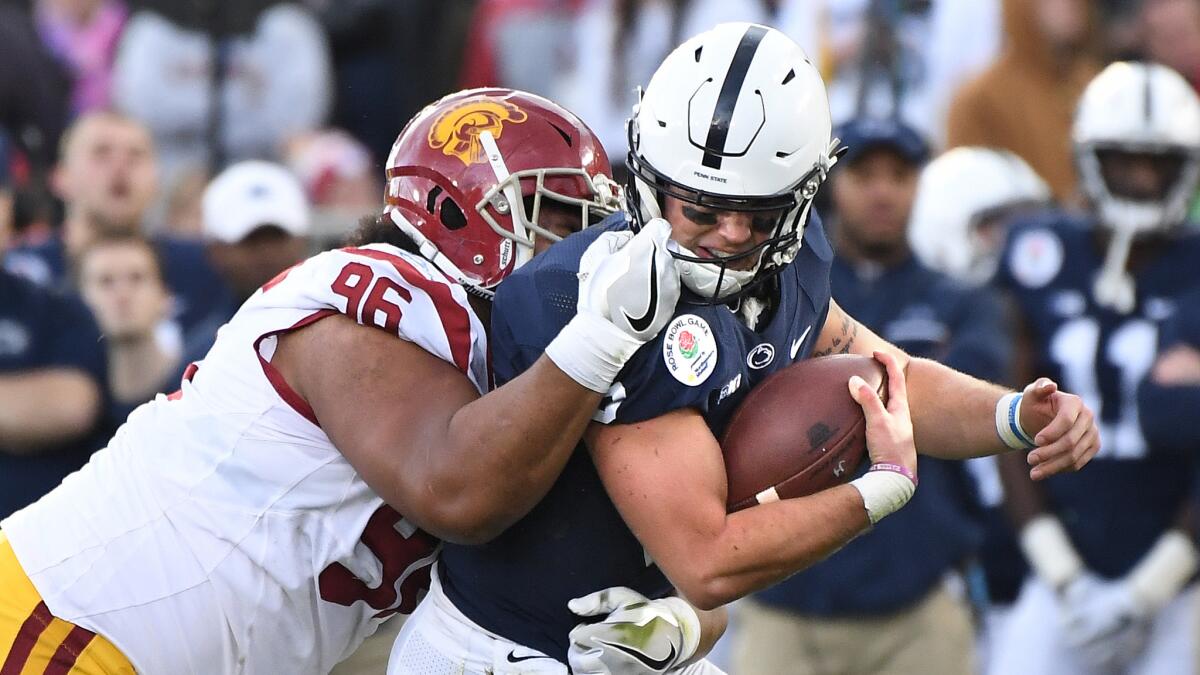 USC's Stevie Tu'ikolowafu grabs the face mask of Penn State quarterback Trace McSorley for a penalty during the Rose Bowl on Jan. 2.