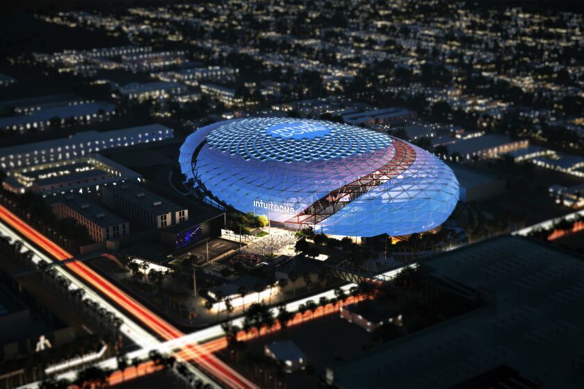An artist's rendering shows an aerial view of the Clippers' news arena, The Intuit Dome, at night.