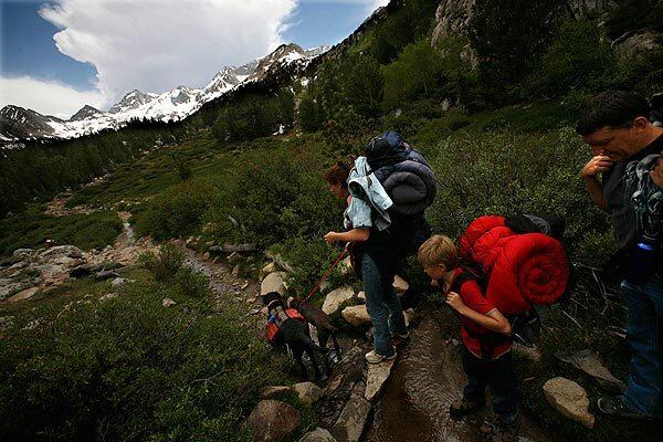 Anthony Kernazitskas, right, wife Mandie and sons David and William (not shown) begin a five-day backpacking trip in the Sierra Nevada near Bishop, which gets 70% of its revenue from outdoor recreation tourists.