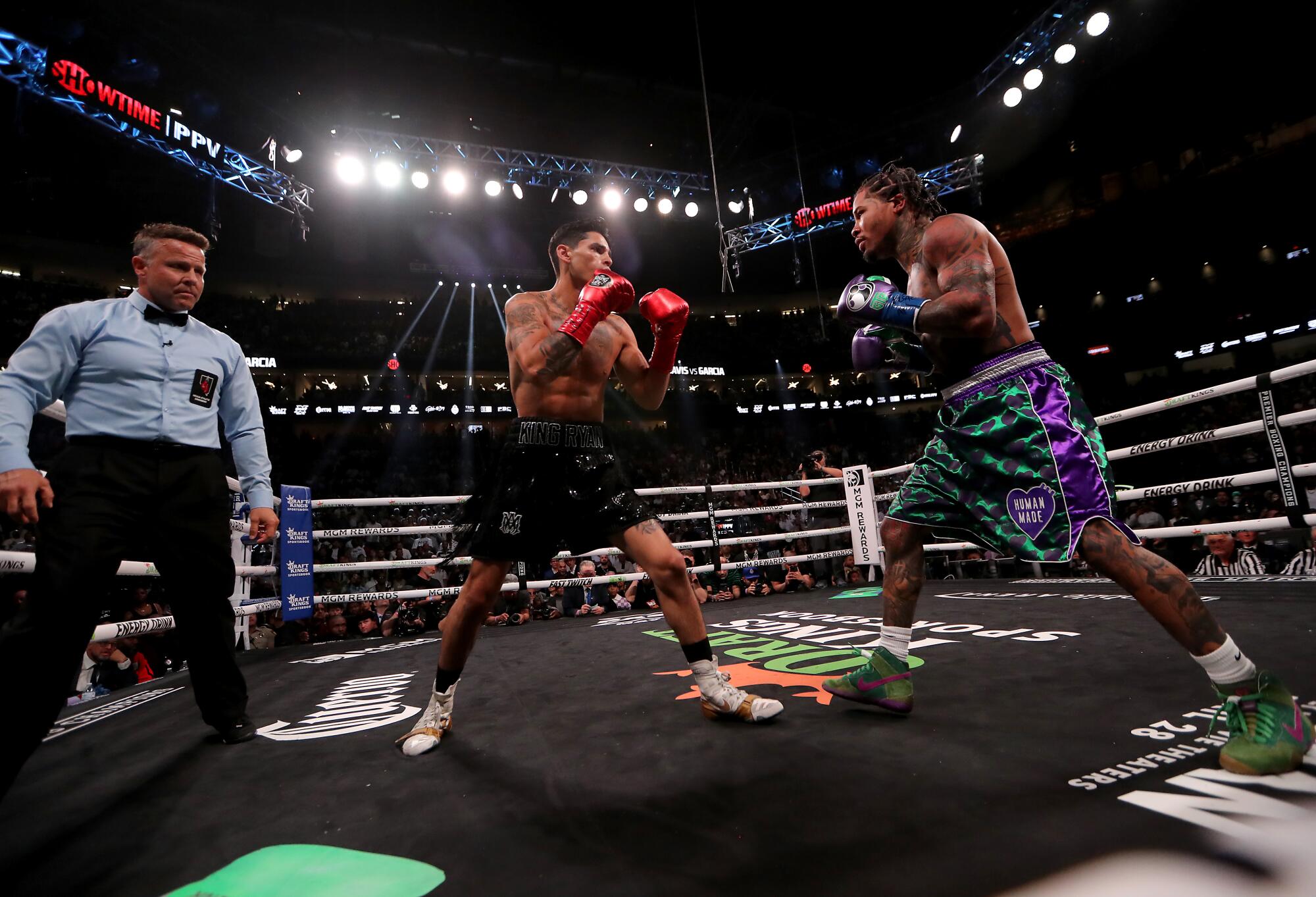 Ryan Garcia and Gervonta Davis square off in the center of the ring 