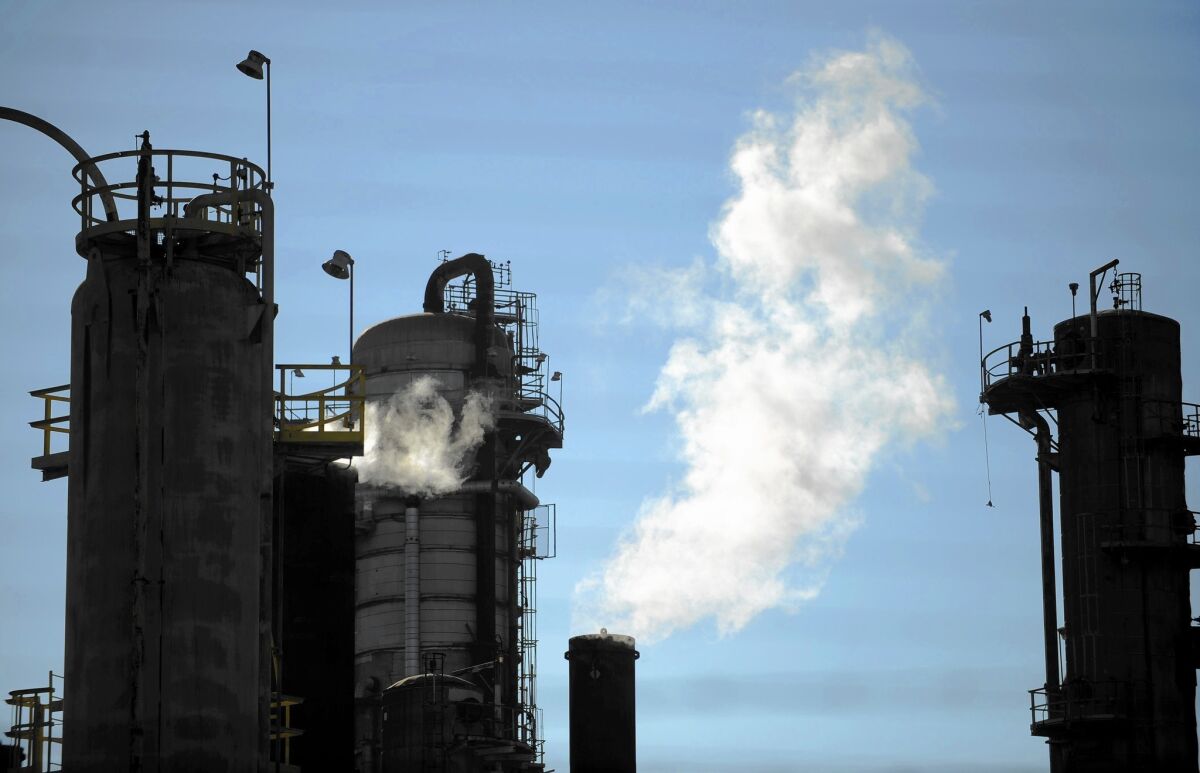 Exxon Mobil, which operates a refinery in Torrance, above, has issued statements denying news reports that it suppressed climate-change research.