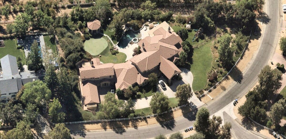The almost 12,000-square-foot home sits on about 1.5 acres in guard-gated Hidden Hills.