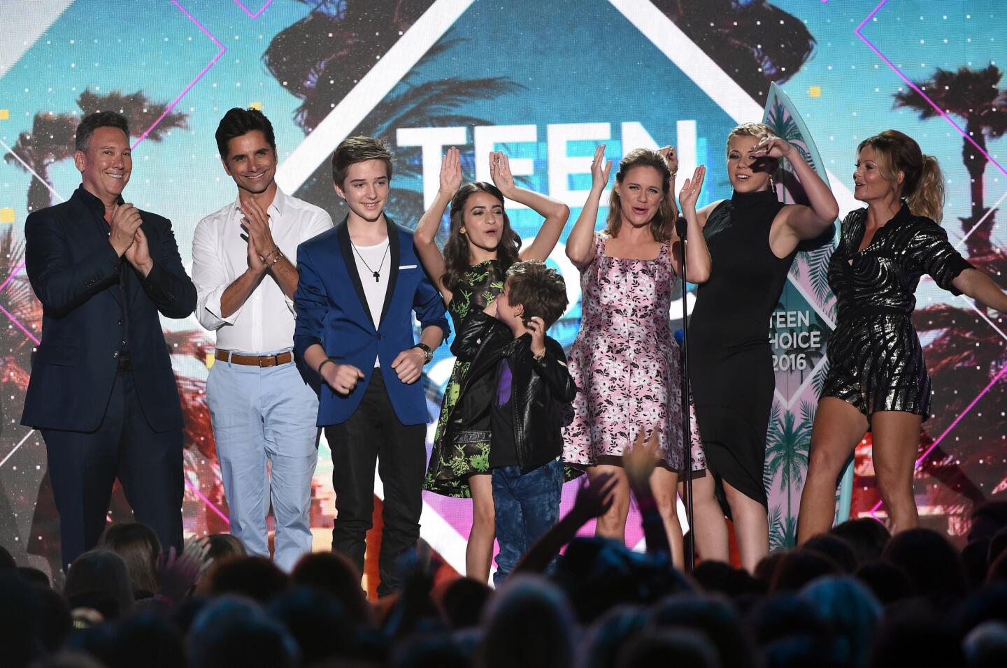 Writer/producer Jeff Franklin, from left, and actors John Stamos, Michael Campion, Soni Nicole Bringas, Elias Harger, Andrea Barber, Jodie Sweetin and Candace Cameron Bure accept the Choice TV Comedy award for "Fuller House" at the Teen Choice Awards 2016 at the Forum in Inglewood.