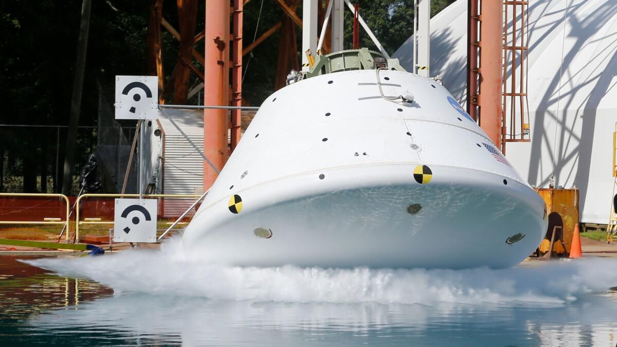 A mockup of NASA's Orion, which is designed to eventually travel to Mars, hits the water in a simulated ocean splashdown test at NASA Langley Research Center in Hampton, Va. (Steve Helber / AP)