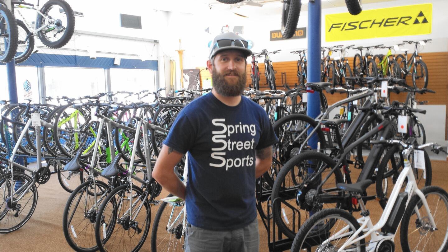 Nate Seckora of Spring Street Bikes rents bicycles in a community where off-road biking is becoming popular with locals and tourists.