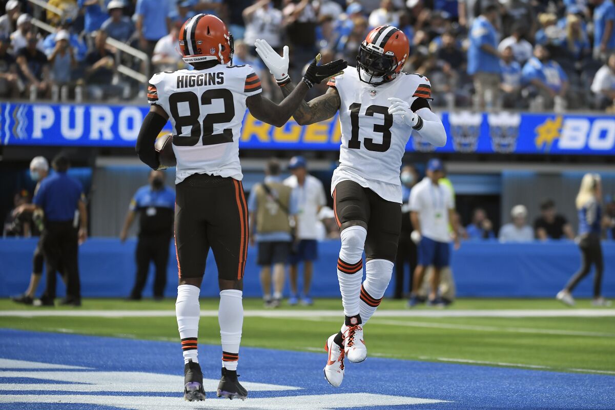 Cleveland Browns wide receiver Rashard Higgins (82) celebrates his touchdown catch with wide receiver Odell Beckham Jr. (13) during the first half of an NFL football game against the Los Angeles Chargers Sunday, Oct. 10, 2021, in Inglewood, Calif. (AP Photo/Kevork Djansezian)