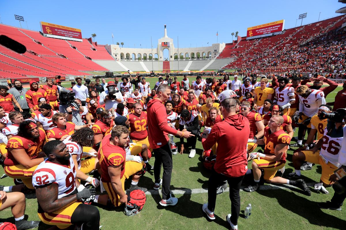 USC coach Lincoln Riley, center, speaks with the team after the spring game at the Coliseum on April 15, 2023. 