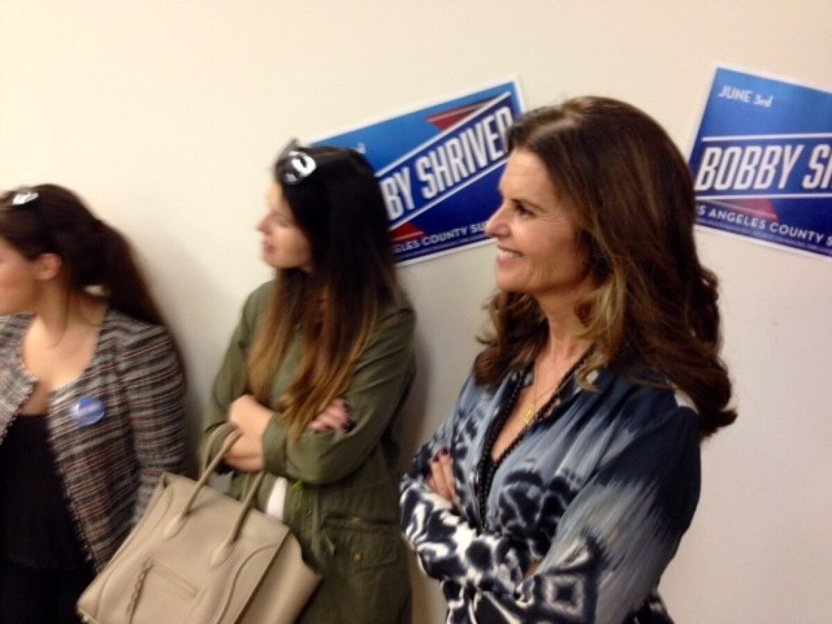 Maria Shriver watches her older brother, Bobby Shriver, address supporters at a campaign event in Santa Monica.