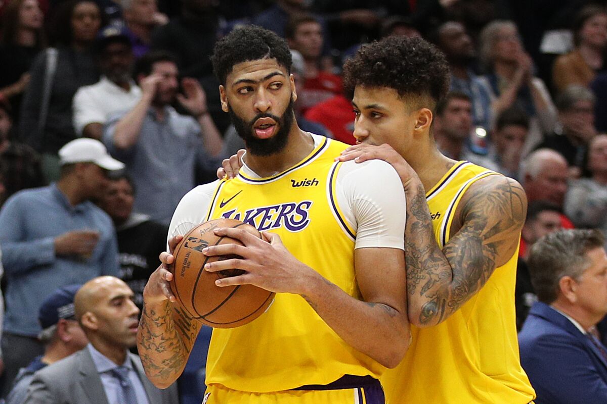 Lakers forwards Anthony Davis, left, and Kyle Kuzma celebrate after Davis stole a pass against the Pelicans during his return to New Orleans on Nov. 27, 2019.