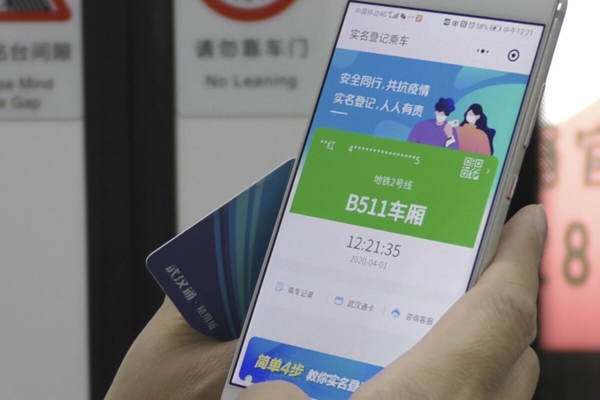 A green pass on a smartphone says a user is symptom-free and is required to board a subway, check into a hotel or just enter Wuhan, China.