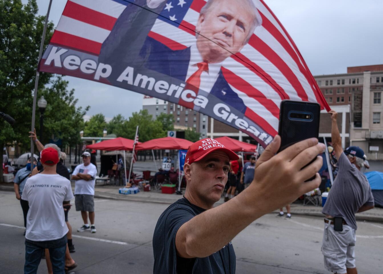 A supporter of President Trump takes a selfie near the BOK Center in Tulsa.