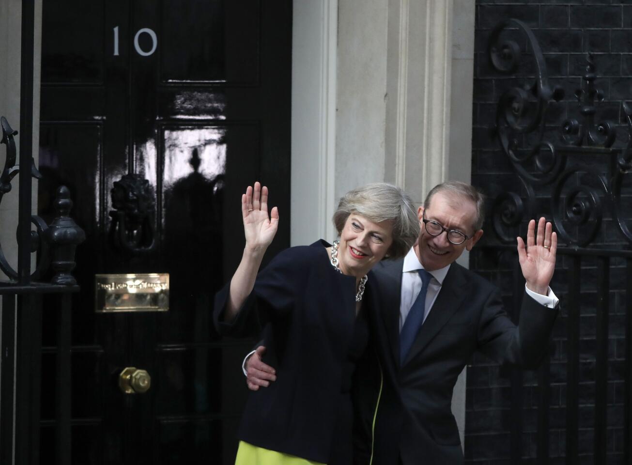 Newly appointed Prime Minister Theresa May, with her husband Philip, arrives to take up residence in 10 Downing Street on July 13, 2016 in London.