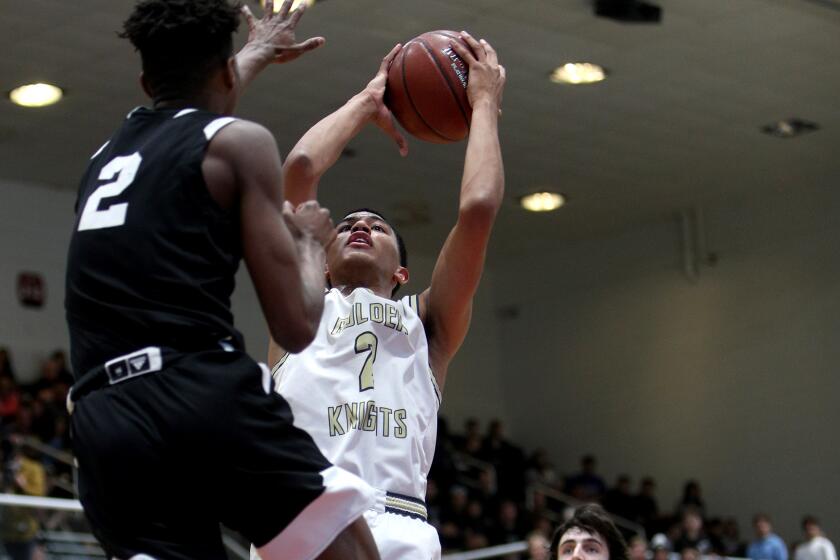 St. Francis' Andre Henry takes a shot under pressure from Santa Clarita Christian's Josh O'Garro during the Southern Section Division 2AA championship game on Feb. 29, 2020, at Azusa Pacific University.