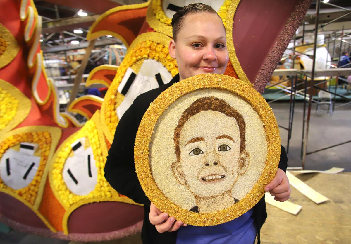 Regina Meaux, of Anaheim, holds a floragraph portrait of her son Ivan Sandoval, who will be honored in the Rose Parade.