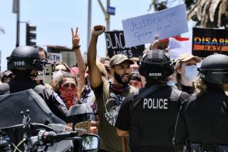 Protesters face off against Santa Monica police on Sunday.