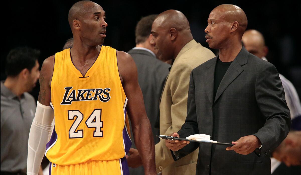 Lakers Coach Byron Scott talks with Kobe Bryant during a break in play against the Warriors last week at Staples Center.
