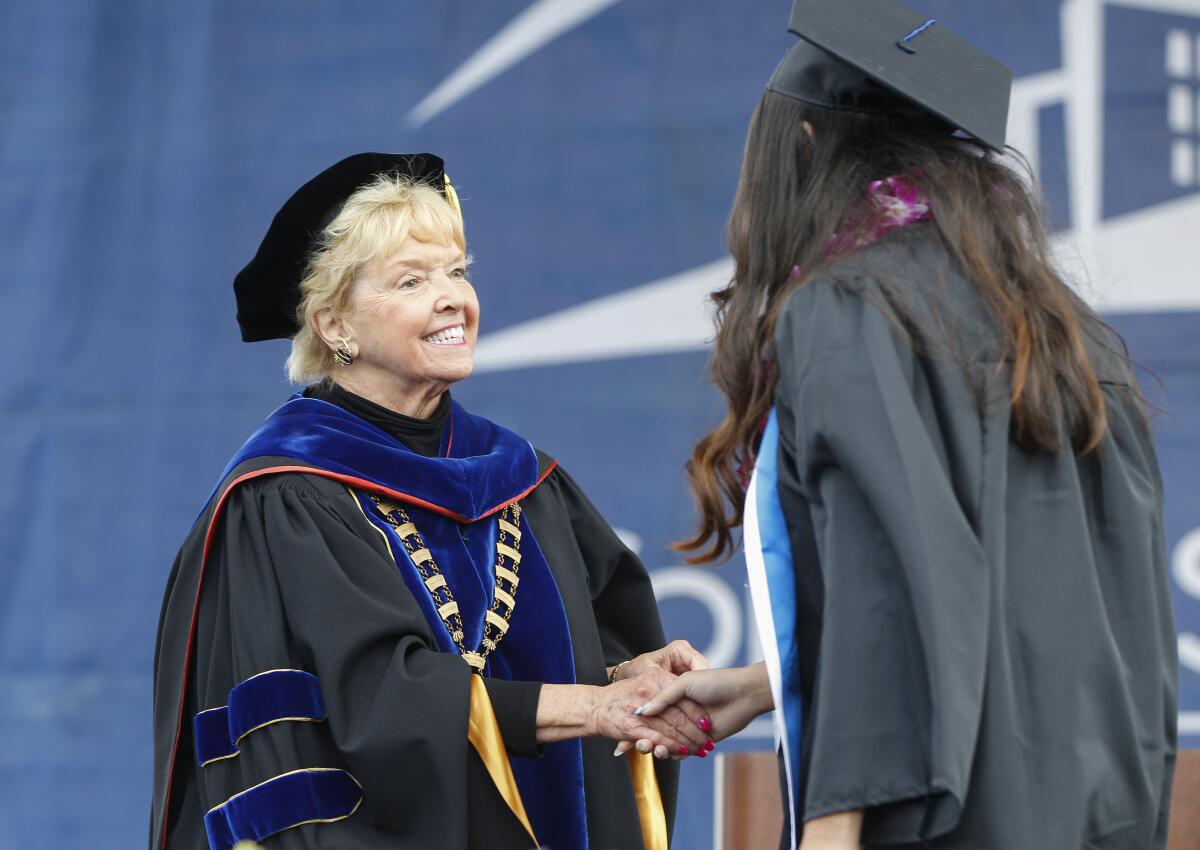 Retiring Can State San Marcos President Karen Haynes congratulates a student at a 2019 graduation in San Marcos.