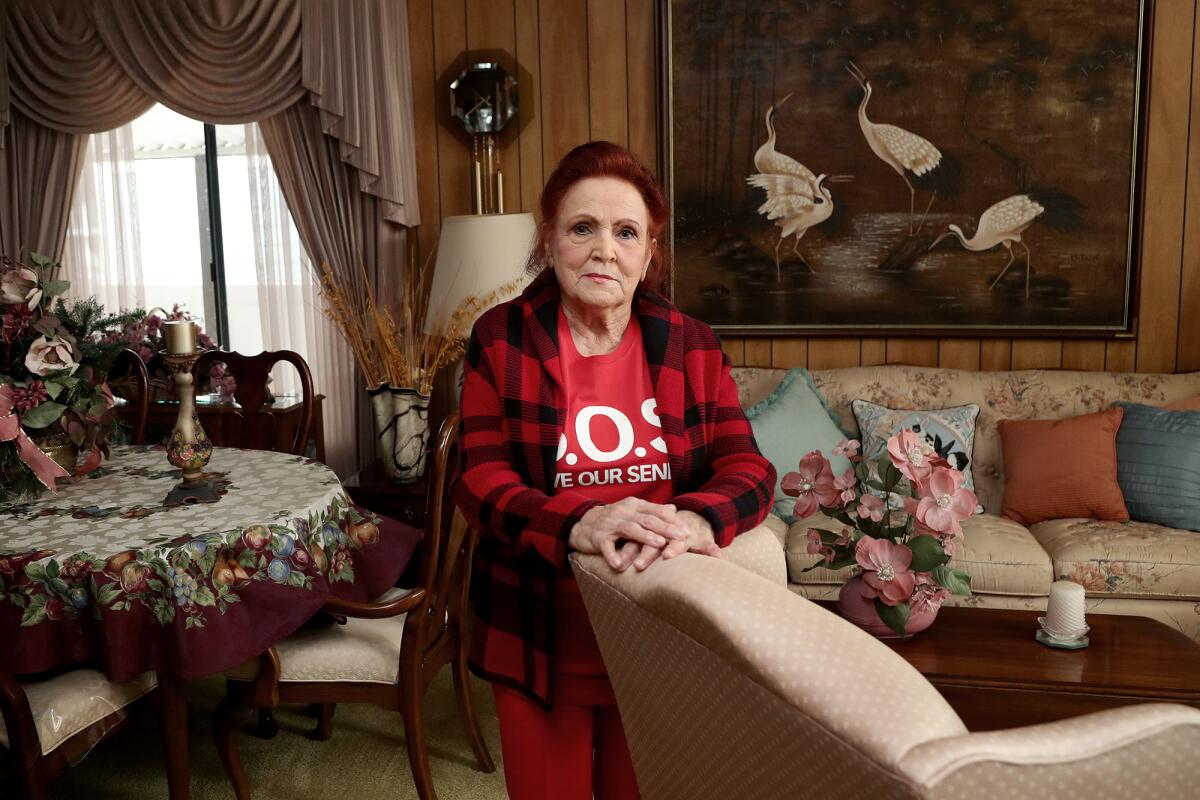 Lynn Plumb, 86, a resident at Skandia Mobile Home Park, poses for a portrait in her home on Tuesday in Huntington Beach.