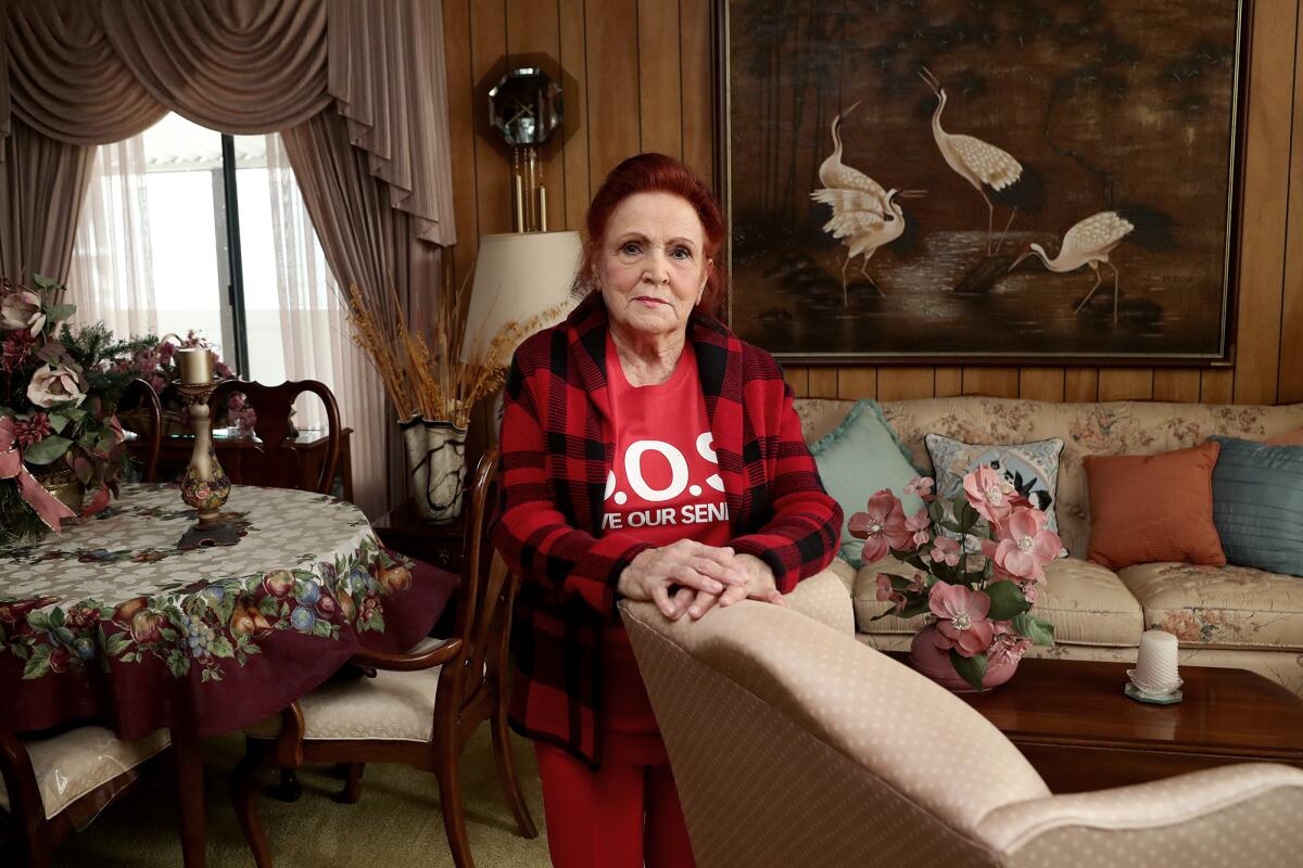 Lynn Plumb, 86, a resident at Skandia Mobile Home Park, poses for a portrait in her home on Tuesday in Huntington Beach. 