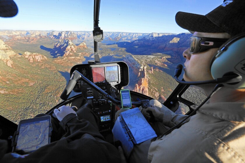 Student pilot Ryan Smith, right, flies an R-44 helicopter over the canyons and mesas near Sedona, Ariz., with Guidance Aviation instructor Jeremy Noland.