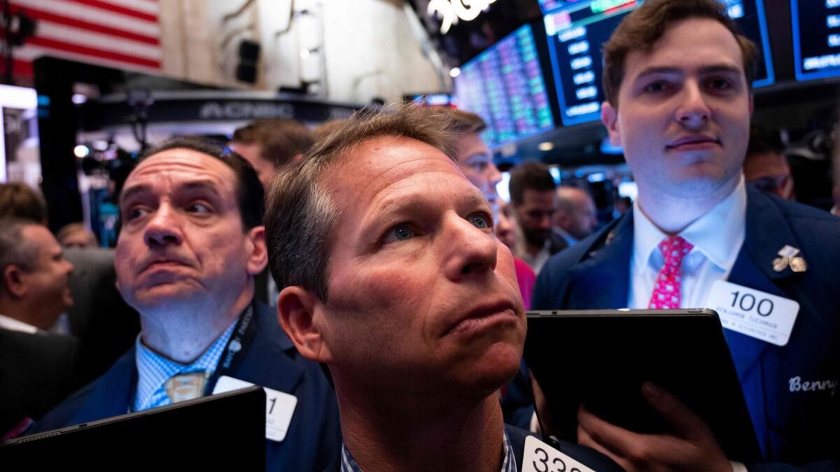 Traders work on the floor of the New York Stock Exchange.