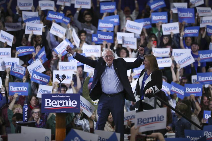 Democratic presidential candidate Sen. Bernie Sanders, I-Vt., accompanied by his wife Jane O'Meara Sanders, arrives to speak during a primary night election rally in Essex Junction, Vt., Tuesday, March 3, 2020. (AP Photo/Charles Krupa)
