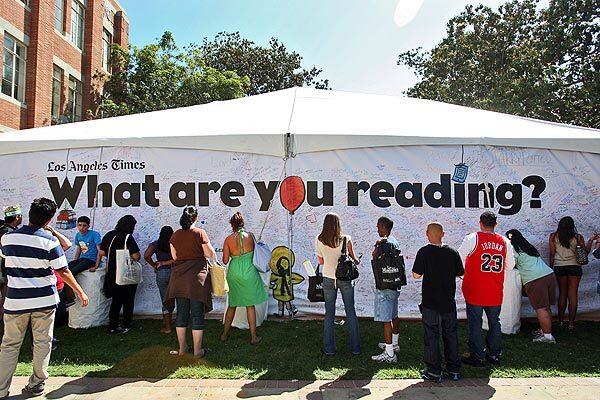 On one of the hundreds of tents set up across the USC campus, Los Angeles Times Festival of Books attendees write the titles of the books they're reading — or are about to read. See full story