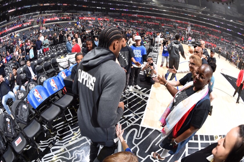 cClippers star Kawhi Leonard heads to the court with his former teachers lined up for high-fives.