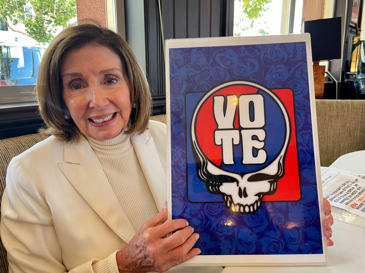 Nancy Pelosi with a Grateful Dead "Vote" poster