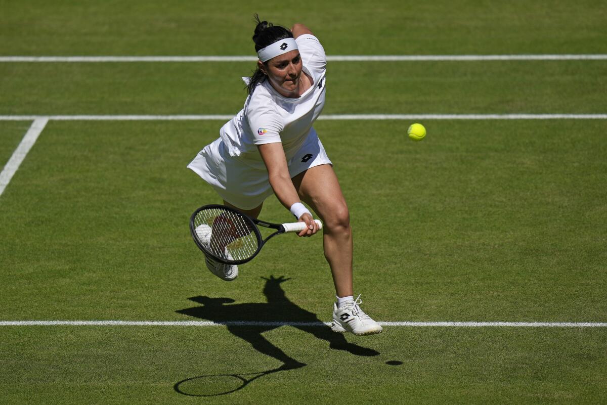 Tunisia's Ons Jabeur returns to Germany's Tatjana Maria in a women's singles semifinal match on day eleven of the Wimbledon tennis championships in London, Thursday, July 7, 2022. (AP Photo/Alastair Grant)