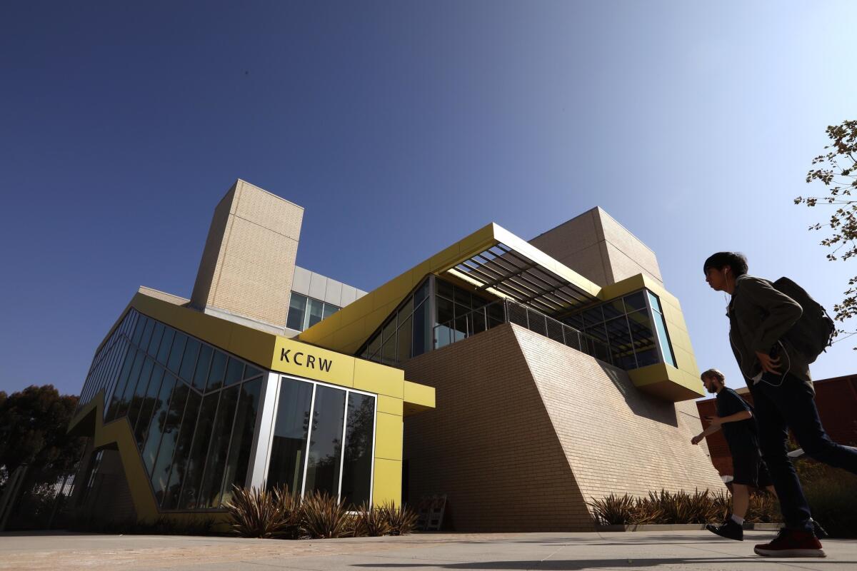 Pedestrians walk in front of KCRW headquarters in Santa Monica