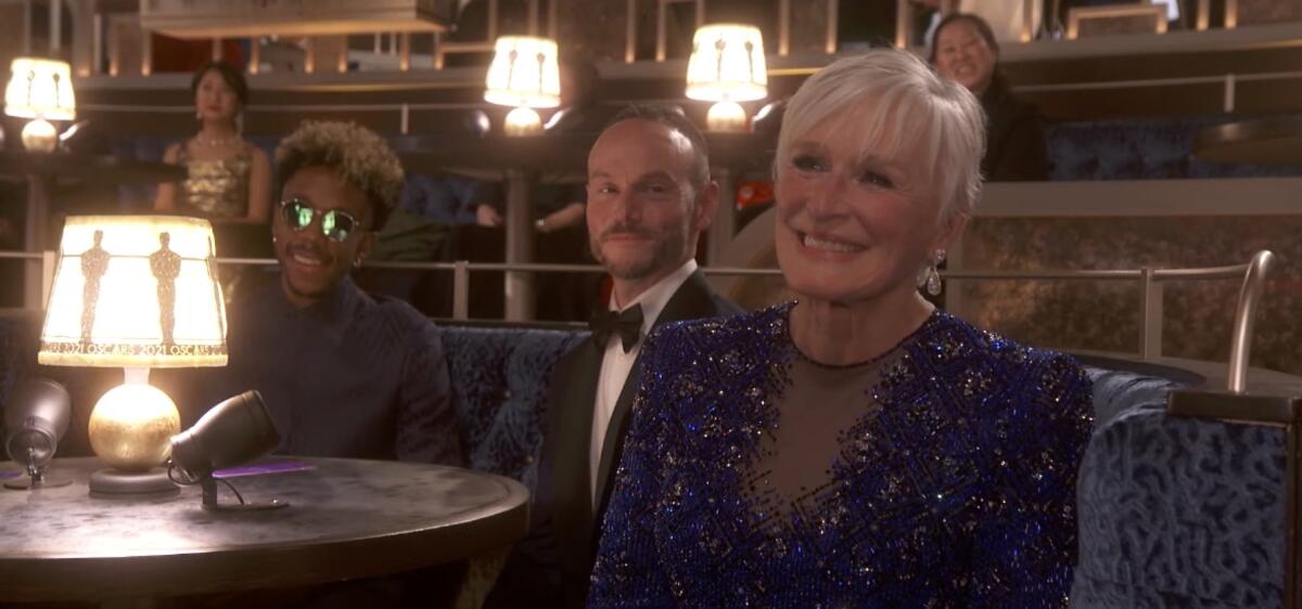 Glenn Close smiling in a sparkly purple dress
