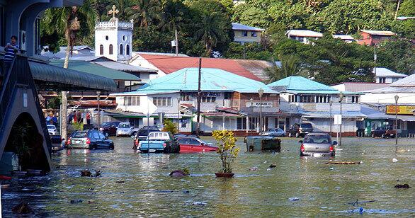 The downtown area of Fagatogo, a town of 3,000 on the shore of Pago Pago Harbor in American Samoa, is submerged by seawater after a massive tsunami flattened villages and swept cars and people out to sea. Triggered by a powerful underwater earthquake, four tsunami waves 15 to 20 feet high roared ashore on American Samoa, reaching up to a mile inland.