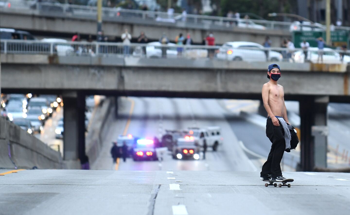 A protester rides a skateboard on the 110 Freeway.