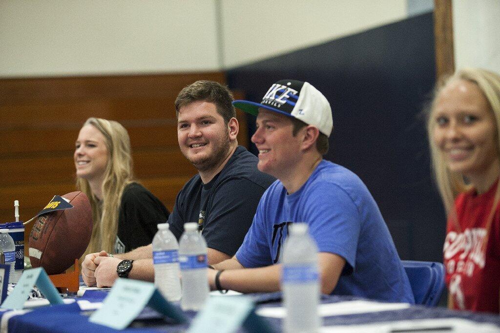 Carolyn Bockrath, left, Ramsey Hufford, Colin Duffy and Jessica Prather attend a National Letter of Intent signing day photo opportunity at Newport Harbor High .