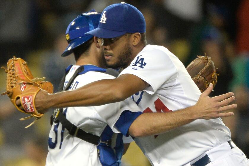 Dodgers closer Kenley Jansen, right, celebrates with catcher Drew Butera following the team's 5-2 win over the Chicago White Sox at Dodger Stadium on Monday.