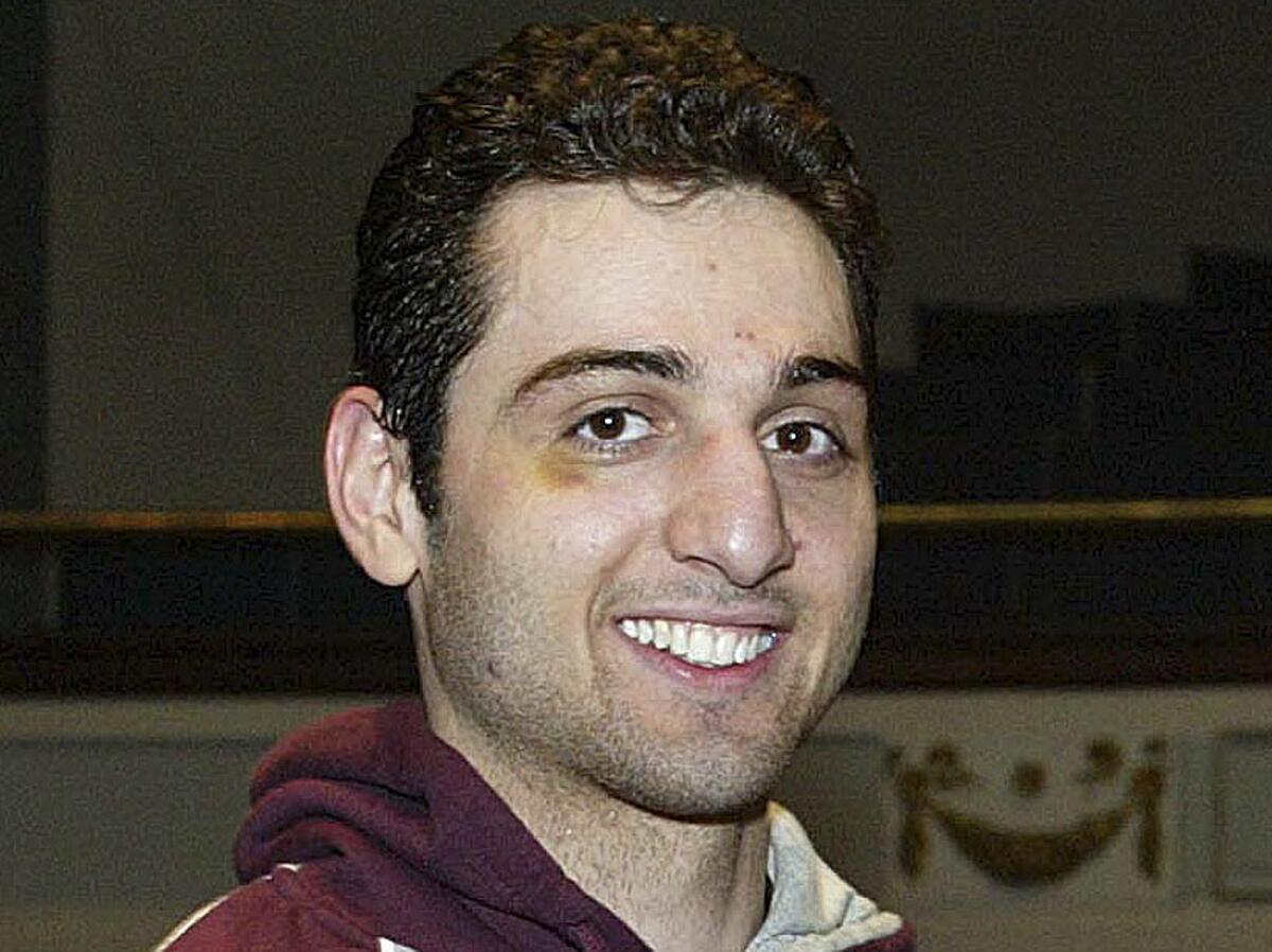 Alleged Boston Marathon bomber Tamerlan Tsarnaev smiles after accepting the trophy for winning the 2010 New England Golden Gloves Championship in Lowell, Mass.